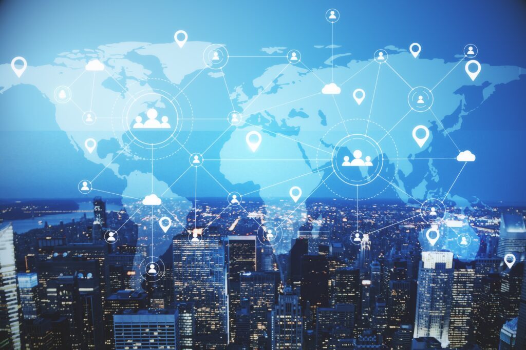 A digital world map overlays a cityscape at night, showing interconnected network icons and location markers