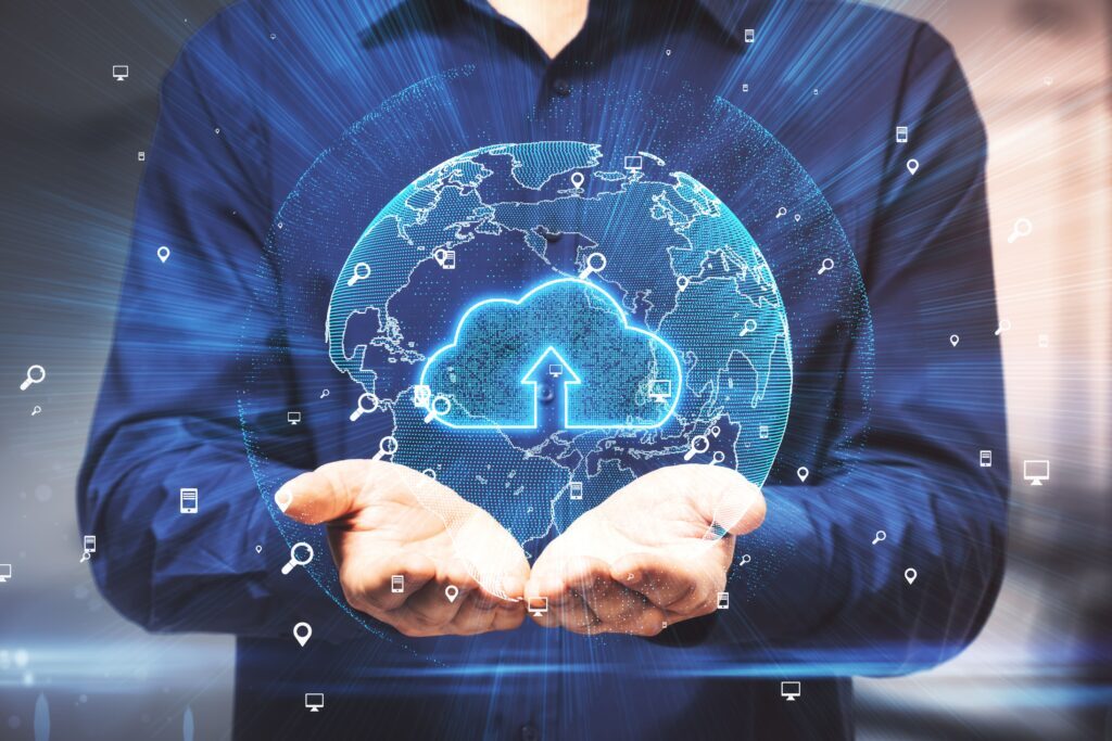 A person in a dark shirt holds a holographic globe with a glowing cloud and upload arrow at the center.